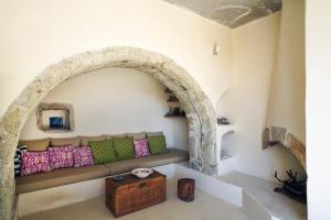 a living room with a couch in an archway at Paleopoli Cave House in Kythira