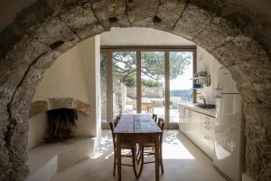 an archway in a kitchen with a table and a fireplace at Paleopoli Cave House in Kythira