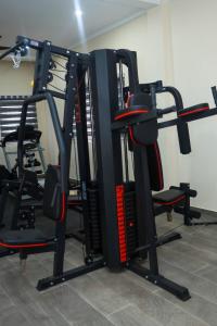 a gym with several tread machines in a room at Judah Chaim Apartments in Ashaiman