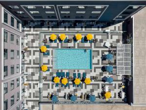 an aerial view of a building with a swimming pool at Hilton Buena Park Anaheim in Buena Park