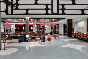 a lobby with couches and chairs in a building at Hilton Buena Park Anaheim in Buena Park +24 photos