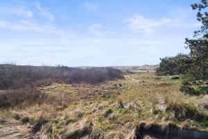 a field with tall grass and trees and a blue sky at Co's Duyne - Beautiful studio near the dunes of Callantsoog in Callantsoog