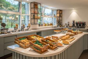 a buffet with many different types of food on a table at Hampton By Hilton Locarno in Losone