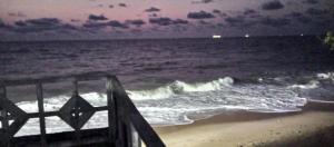 a view of the ocean at night from the beach at Black Diamond Appartements in Kribi