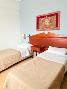 Postel nebo postele na pokoji v ubytování D'Angelo Palace Hotel