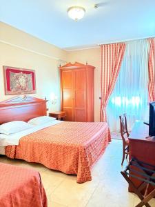 Postel nebo postele na pokoji v ubytování D'Angelo Palace Hotel