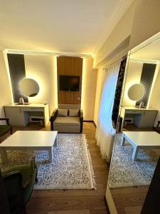 a hotel room with a couch and a tv at Saylamlar Hotel in Trabzon