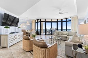 a living room with a couch and a tv at The Oasis at Orange Beach 2206 (Phoenix West II) in Orange Beach