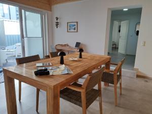 a wooden table with chairs in a living room at HeimatHafen & Meer in Sassnitz