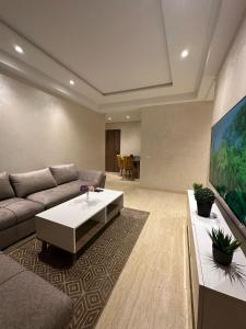 a living room with a couch and a table at L'opera luxury apartment Sidi Maarouf - Near Casa Nearshore in Casablanca