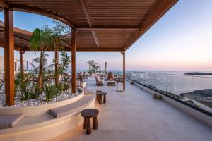 a resort with a view of the ocean at Isla Brown Chania Resort, Curio Collection by Hilton in Stavros