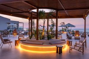 a restaurant with a large centerpiece with chairs and tables at Isla Brown Chania Resort, Curio Collection by Hilton in Stavros