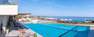 an image of a swimming pool at a resort at Isla Brown Chania Resort, Curio Collection by Hilton in Stavros