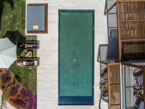 a green door on the side of a building at Isla Brown Chania Resort, Curio Collection by Hilton in Stavros