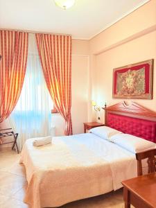Postel nebo postele na pokoji v ubytování D'Angelo Palace Hotel