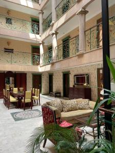 a lobby with a couch and a table and chairs at Maxwell Suites in Marmaris