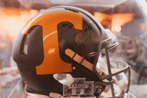 an orange and black football helmet with graffiti on it at Graduate by Hilton Knoxville in Knoxville