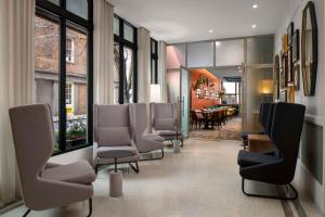 新奥尔良Hotel Theo New Orleans, Tapestry Collection by Hilton的一间设有椅子的等候室和一间餐厅