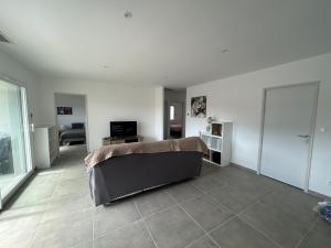 a bedroom with a bed and a living room at Villa daudet in Vallon-Pont-dʼArc