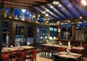 a restaurant with tables and chairs in a room at Barnesmore Cottage with views Dog Friendly in Barnesmore