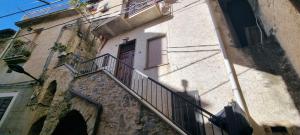 a building with a staircase leading up to a door at Iris in Rodio