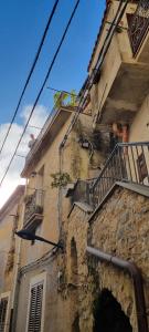 a stone building with a staircase and a balcony at Iris in Rodio