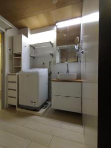 a bathroom with a sink and a mirror at 下町の穴場 キッチン完備 長期滞在に最適なお部屋 Rapyuta monthly apartment in Kyoto +291 photos