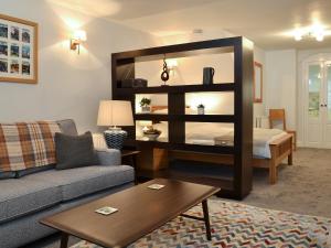 a living room with a couch and a large mirror at Lower Sycamore Cottage in Ambleside