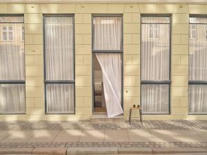 a building with a window with a curtain on it at Noura Residency City Apartment II in Copenhagen +48 photos