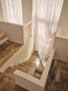 a staircase in a room with a curtain at Noura Residency City Apartment II in Copenhagen