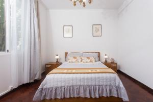 a bedroom with a bed with two dogs laying on it at Rochinha Cozy Home in Funchal