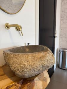 a stone sink in a bathroom with a mirror at Hart van Petten in Petten +47 photos