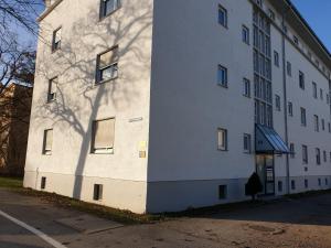 a building with a shadow of a tree on the side of it at Im Cube in Augsburg