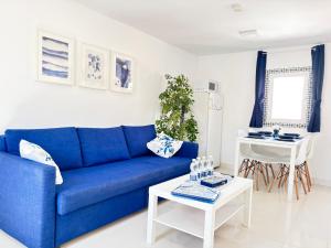 a blue couch in a living room with a table at Marbella Center Apartment in Marbella