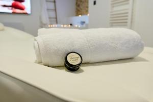 a stack of towels sitting on a counter in a bathroom at Love room évasion in Tuchan