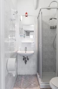 a white bathroom with a sink and a shower at Ai Musei Vaticani BB in Rome