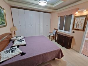 a bedroom with a bed and a desk and a window at Villa Costa Adeje in Adeje +29 photos