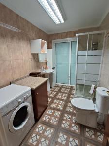 a bathroom with a washing machine and a toilet at Villa Costa Adeje in Adeje