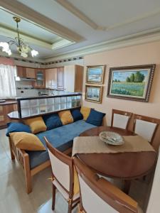 a living room with a blue couch and a table at Villa Costa Adeje in Adeje