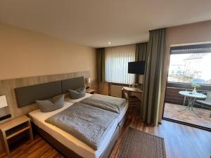 a bedroom with a bed and a large window at Annas Gästehaus in Hallerndorf