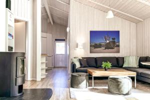 a living room with a couch and a table at Strandblick - Dorf 1 Ferienhaus 01 in Priwall