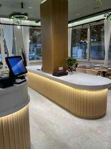 a lobby with a desk with a laptop on it at Hotel Vila Misiri in Durrës