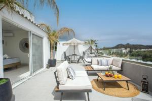 a patio with two couches and a table at JnS Premium Stay in Faliraki