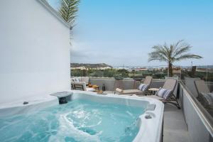 a jacuzzi tub on the balcony of a hotel at JnS Premium Stay in Faliraki