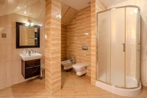 a bathroom with a shower and a toilet and a sink at Hotel Wiktoria in Wiązowna +28 photos