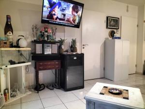 a living room with a tv on the wall at Studio- très calme - Proche Bidart et Guétary " AHETZE" in Ahetze +33 photos