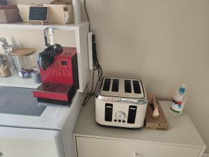 a toaster sitting on top of a counter in a kitchen at Clifton House O2 & Excel Rooms with private bathroom and Breakfast option in London