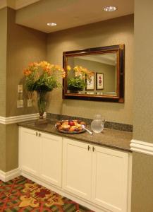 a bathroom counter with a plate of fruit and a mirror at Hampton Inn & Suites - Vicksburg in Vicksburg