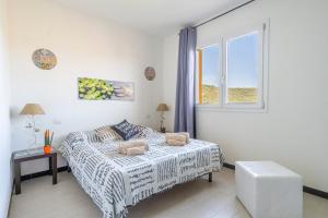 ein weißes Schlafzimmer mit einem Bett und einem Fenster in der Unterkunft Estate in Ogliastra Sa figumoru 5 minuti al mare in Bari Sardo