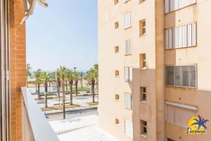 a view from the balcony of a building with palm trees at Center IBERPLAYA in Salou
